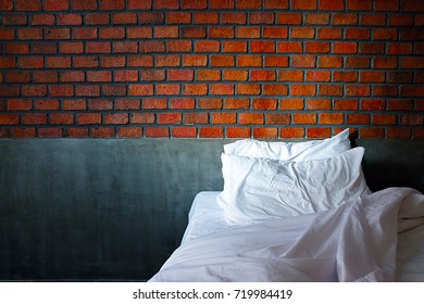 Bed with brick wall