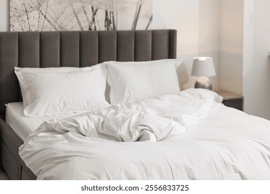 Bed with clean linens and pillows at home