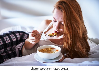 In Bed Eating Chicken Noodle Soup While Sick
