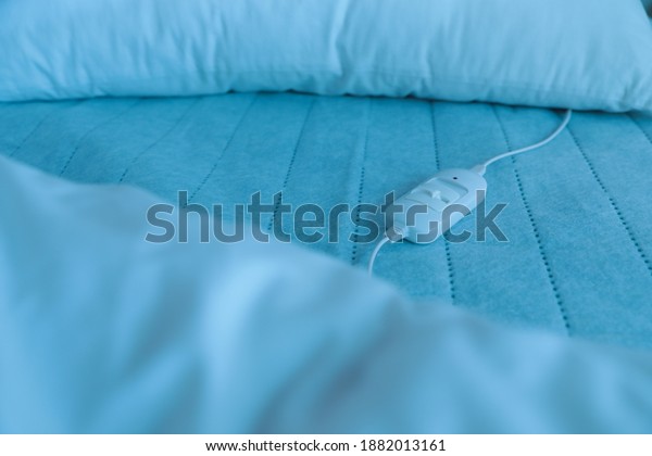 Bed with electric\
heating pad, closeup view