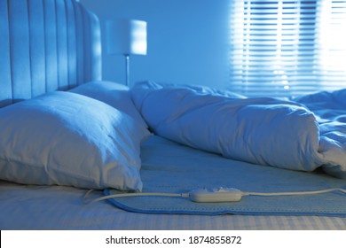 Bed With Electric Heating Pad Indoors At Night