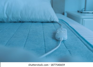 Bed With Electric Heating Pad Indoors, Closeup