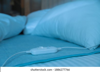 Bed With Electric Heating Pad Indoors At Night