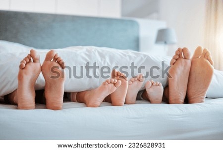 Bed, feet and family together in the morning, sleeping or rest in bedroom on holiday, weekend or vacation. Mom, dad and children resting, dreaming or calm relaxing in home, house or hotel with kids