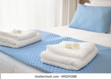 Bed With Fresh Towels And Amenities