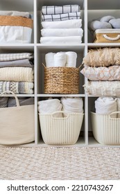 Bed linens closet neatly arrangement on shelves with copy space domestic textile Nordic minimalism comfortable storage. Rolled towels in straw basket duvet cover sheet pillow plaid in cupboard - Shutterstock ID 2210743267