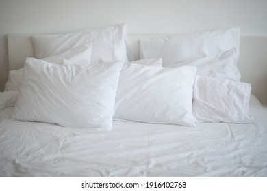 bed made with white linens in the hotel