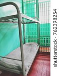 bed in a prison cell