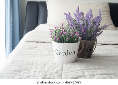 The Bed With Purple Lavender Flower And Pink Rose On Flower Pot And Sunlight From Glass Of Windows  In Bedroom.