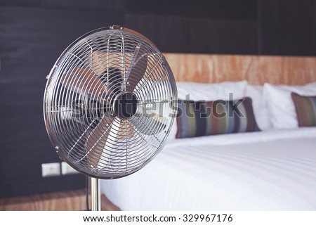 Bed room and metal fan.