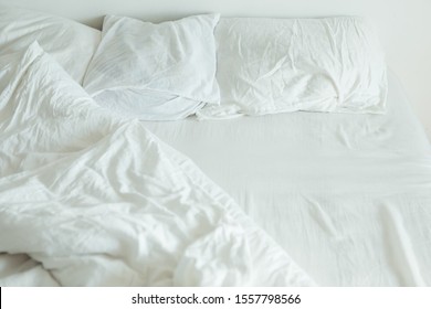 bed with white sheets close up bright light