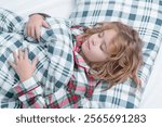 Bedding child. Kid sleeping in bed. Child sleeping in bed under blanket. Kid lying on pillow, child rest asleep, enjoy healthy sleep or nap.