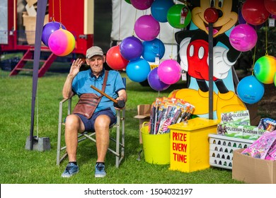 Bedford, Bedfordshire, UK June 2 2019. A Fairground Worker Or Theme Park Attendant Works In A Fairground Or Theme Park, Usually Supervising A Particular Ride Or Stall