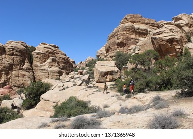 Bedouin guide and two tourists hiking at Dana Biosphere Reserve, Jordan, on March 1st, 2018