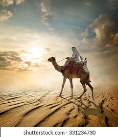 Bedouin rides on camel through sandy desert