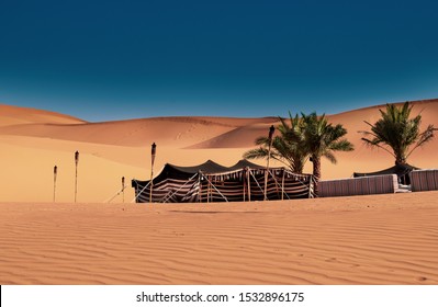 A Bedouin tent set up. Camping in the desert. UAE Abu Dhabi Dubai. Palm Trees in desert oasis