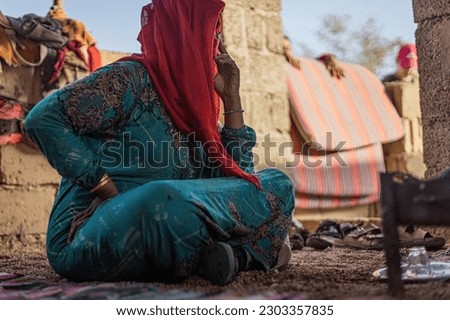 Bedouin woman cooking tea on the fire in Bedouin village, Egypt