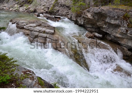 Bedrock dividing water flow of river along Maligne Canyon at Jasper National Park during Summer