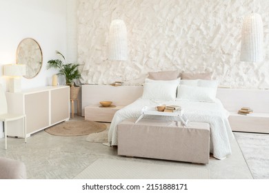 Bedroom Background. Shot Of Spacious Room With Cozy Bed And White Walls. Domestic Comfort, Modern Furniture And Decor, Contemporary Interior Design Concept. No People