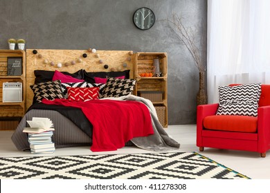 Bedroom With Big Bed, DIY Furniture, Pattern Carpet And Red Armchair