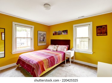 Bedroom In Bright Yellow Color With Single Bed. Red Stripped Bedding