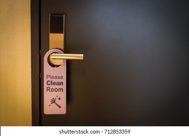 Bedroom Door In A Hotel With A Sign, Please Clean The Hang