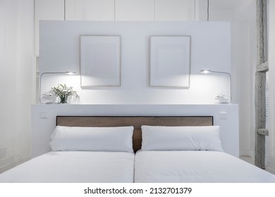 Bedroom With Headboard Painted In White With Wood Detail And Photo Frames