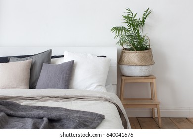 Bedroom interior bed and bedside table with plant - Shutterstock ID 640041676