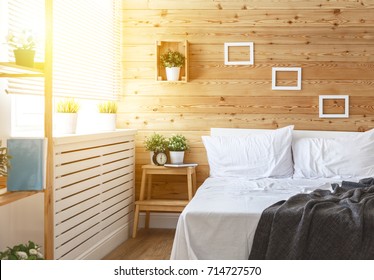 Bedroom Interior With Bed, Window And Wooden Wall
