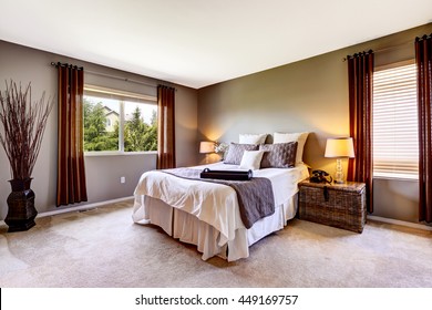 Bedroom Interior With Carpet Floor And Big Bed. American Northwest House