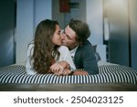 Bedroom, kissing and couple with love, relax and morning with kindness, trust and bonding together. Home, embrace and man with woman, dating and care with romance, hug and marriage with relationship