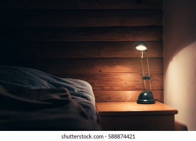 Bedroom Lamp On A Night Table Next To A Sleeping Bed