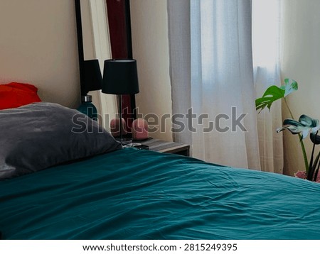 bedroom mirror, rumpled sheets, slept-in beds