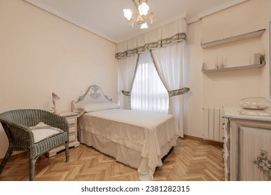 Bedroom with single bed with white duvet, wooden headboard matching the side tables, classic vintage decoration - Powered by Shutterstock