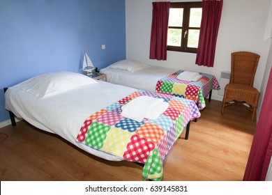 Bedroom With Two Twin Beds In A Colored Ambiance