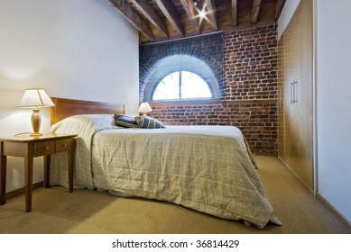 Bedroom In A Warehouse Conversion With Exposed Brick Work