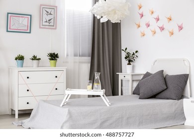 Bedroom in white with grey details and creative origami wall decor