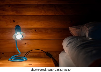 Bedside Lamp In Mountain Cottage Bedroom At Night, No People