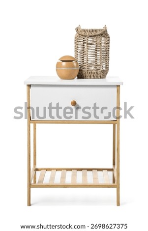 Bedside table with wicker basket on white background