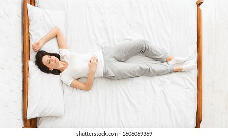 Bedtime. Millennial Woman Sleeping In Bed, Panorama, Top View