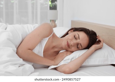 Bedtime. Woman sleeping in bed at home - Powered by Shutterstock