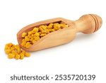 Bee pollen grains in wooden spoon isolated on white background