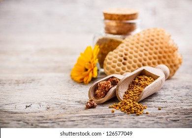 Bee Pollen Granules And Propolis In Wooden Scoop