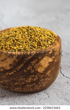 Bee pollen or perga textured background . Raw brown, yellow, orange and blue flower pollen grains or bee bread texture pattern. Healthy food supplement