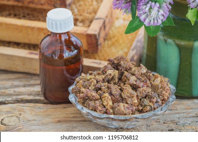 Bee Propolis In A Glass Plate And Propolis Infusion In Alcohol