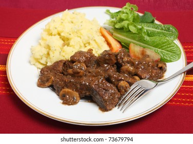 Beef Bourguignon - Beef Braised In A Wine Sauce And Finished With Fried Mushrooms - With Parsley Potatoes And A Salad