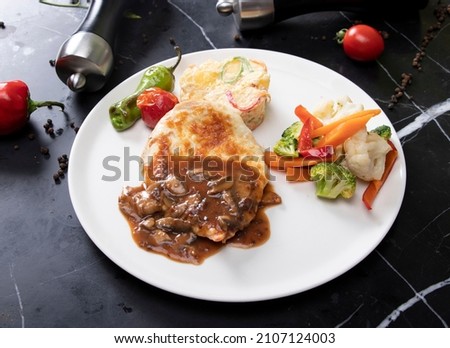 Beef Bourguignon in a pan. Stew with red wine ,carrots, onions, garlic, a bouquet garni, and garnished with pearl onions, mushrooms and bacon.