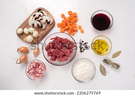 Beef bourguignon. Raw ingredients. Ready to be cooked. Recipe for beef stew, traditional to Burgundy cuisine, cooked in red wine, with a garnish of mushrooms, small onions and bacon. French cuisine. 