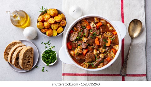 Beef bourguignon stew with vegetables. Grey background. Top view. - Powered by Shutterstock