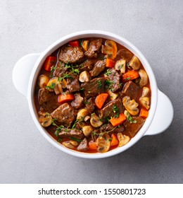 Beef bourguignon stew with vegetables. Grey background. Top view. - Shutterstock ID 1550801723
